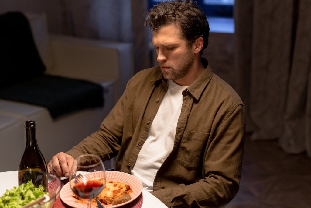 A Man Unbuttoned Long Sleeves Eating Dinner
